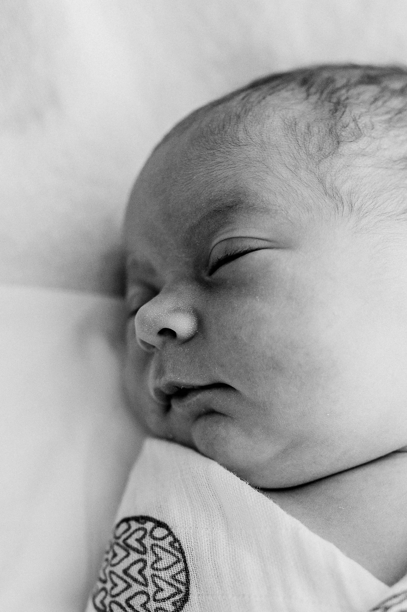 Black-and-white close-up of a baby’s sleeping face