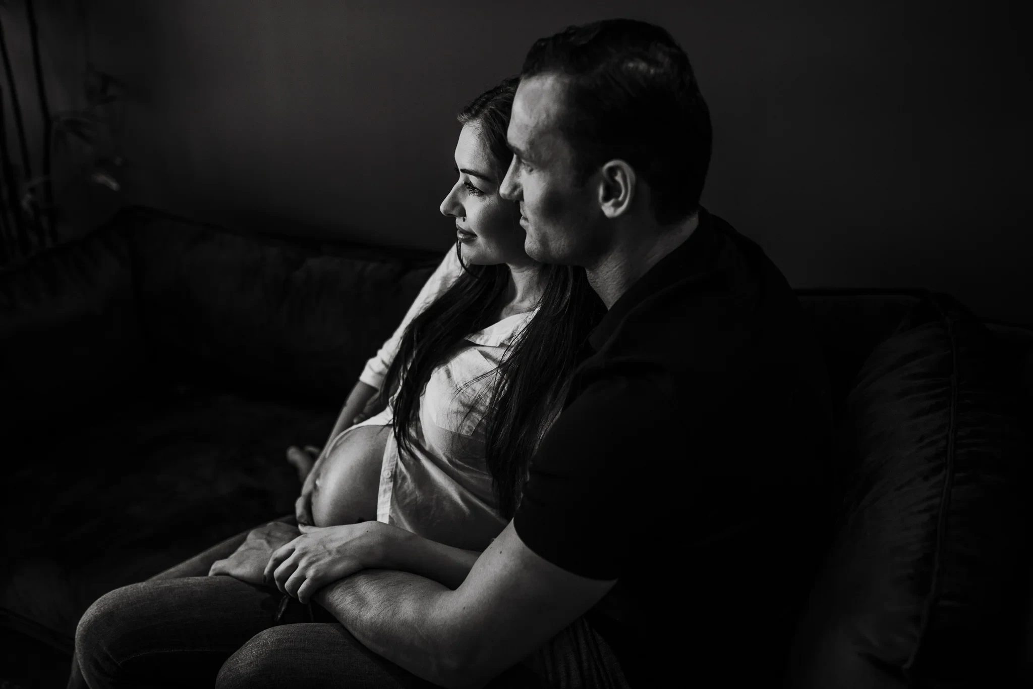Black-and-white photograph of two adults sitting close together on a sofa